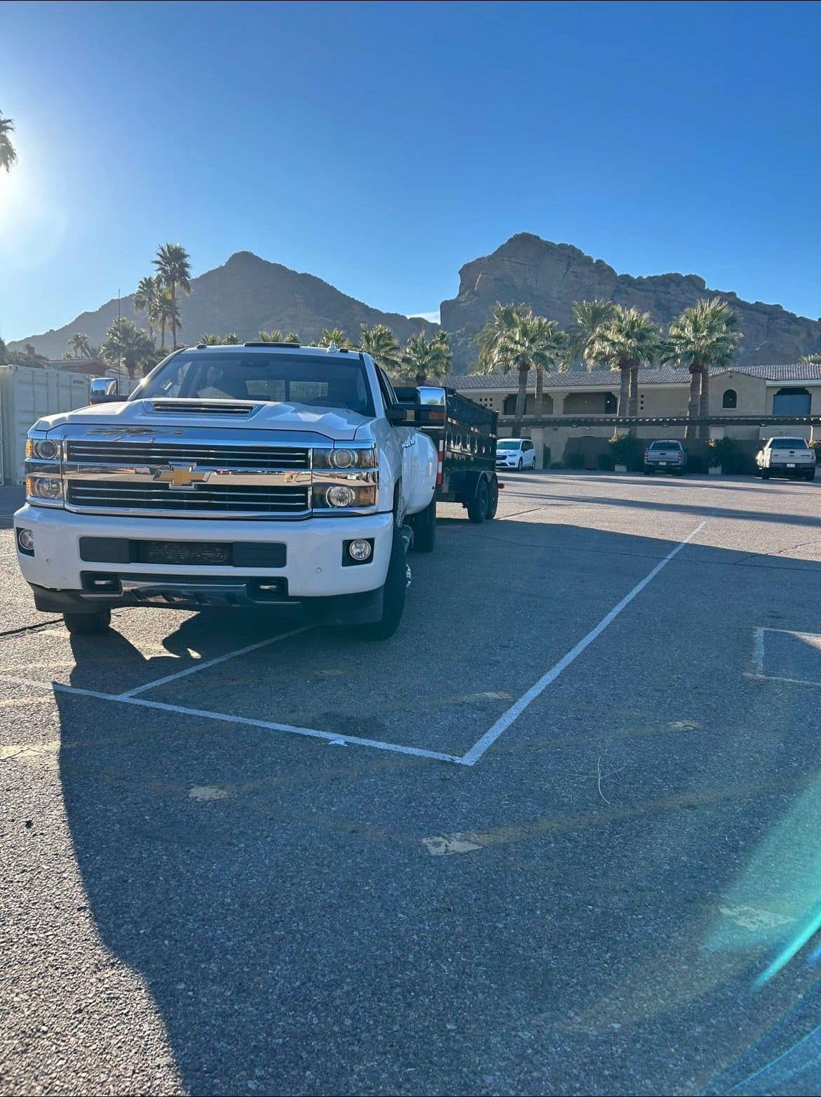 AZ Junk Pros white truck and dump trailer with an Arizona mountain backdrop