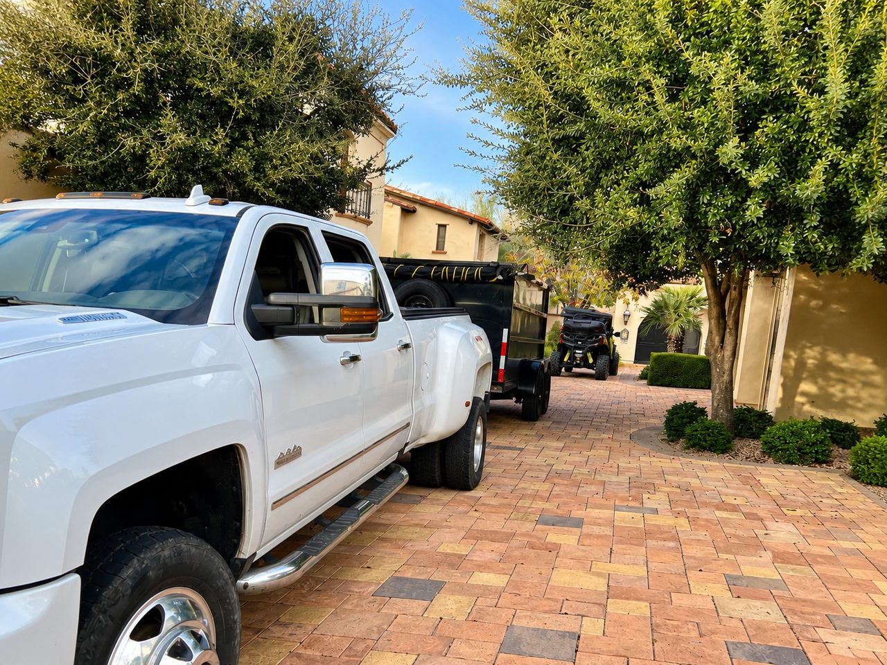 AZ Junk Pros truck and dump trailer parked at a North Phoenix property